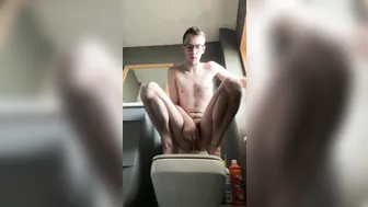 Nerdy pig squats on his toilet to shit