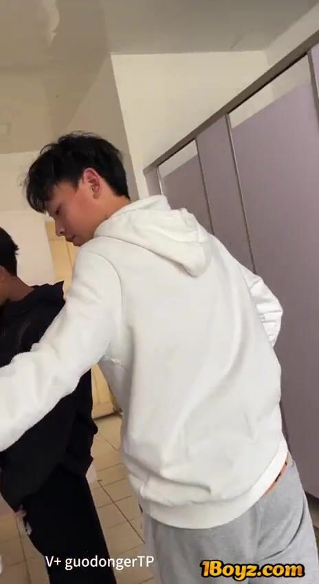 A male student is pissing in the toilet. 2