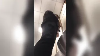 A male is pissing in the toilet. 2