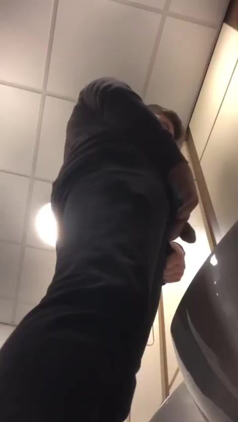 A male is pissing in the toilet. 2