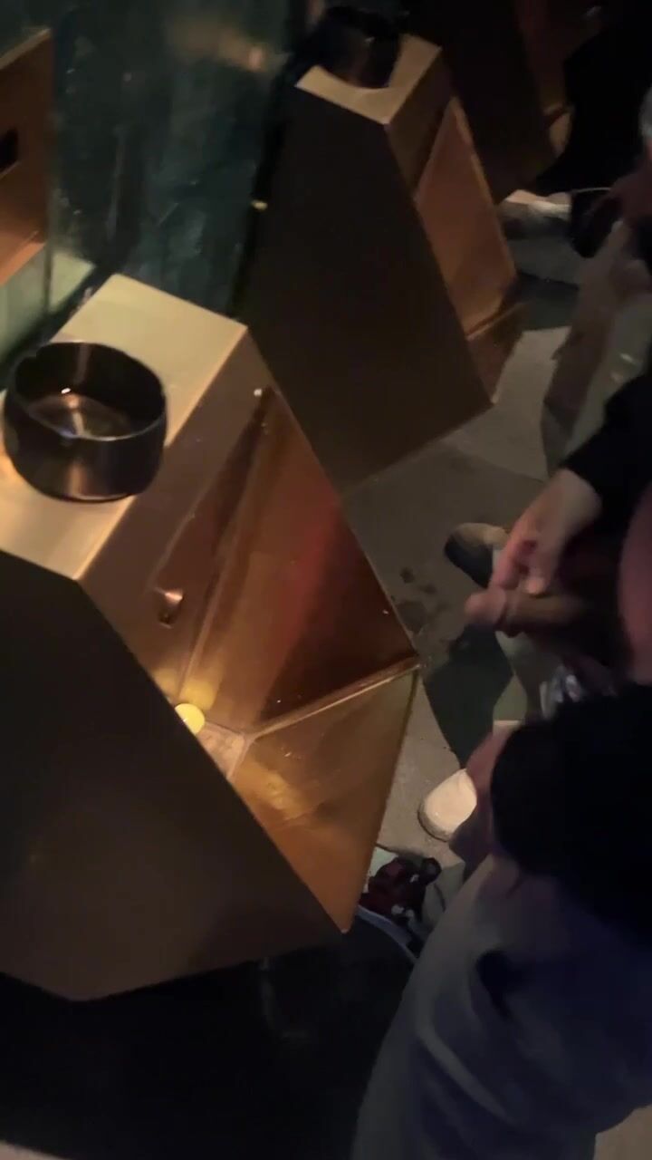 A male is pissing in the toilet. 3