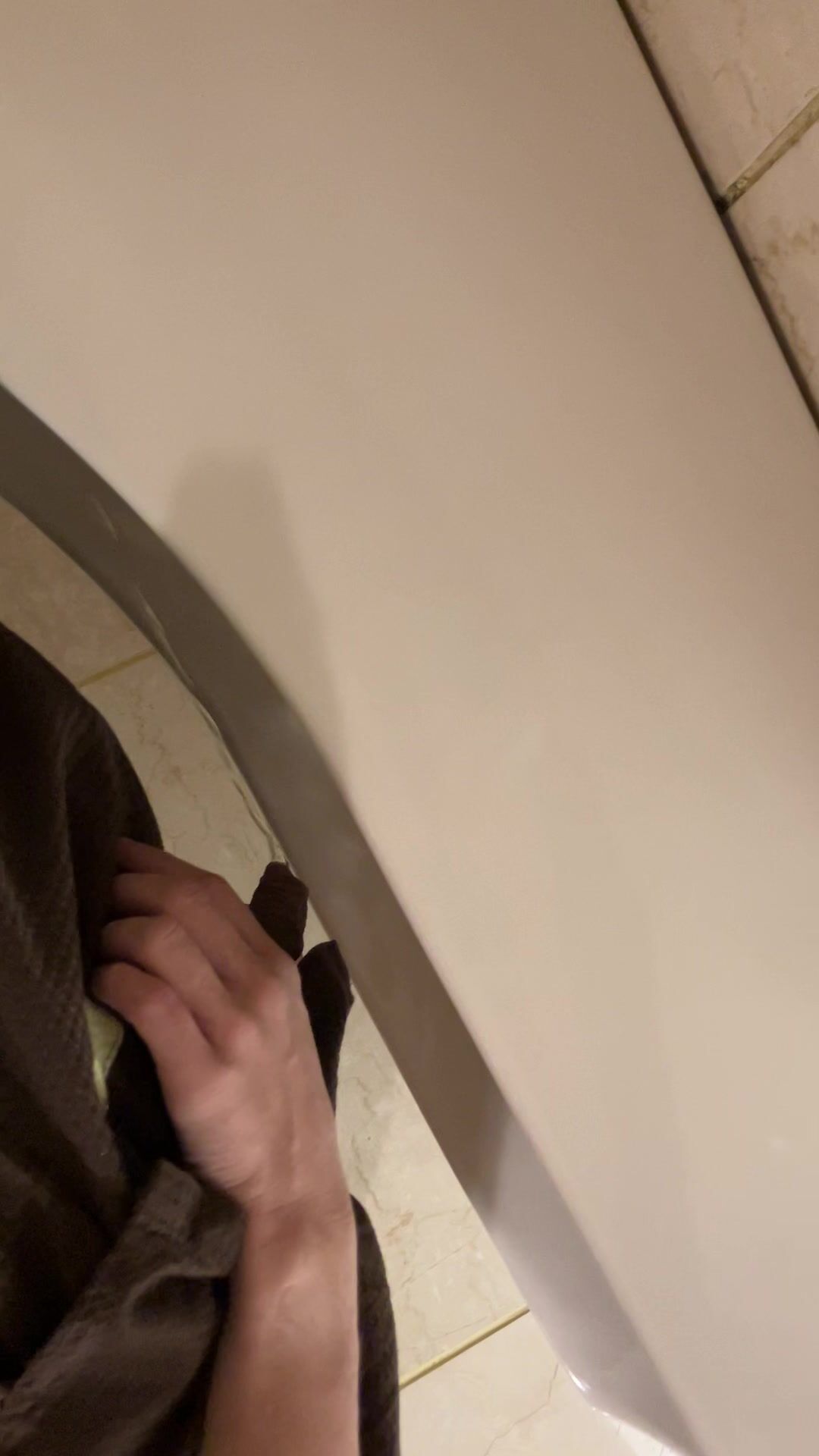 A male is pissing in the toilet. 4