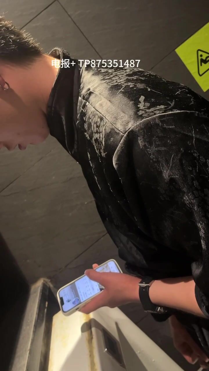 A male is pissing in the toilet. 9