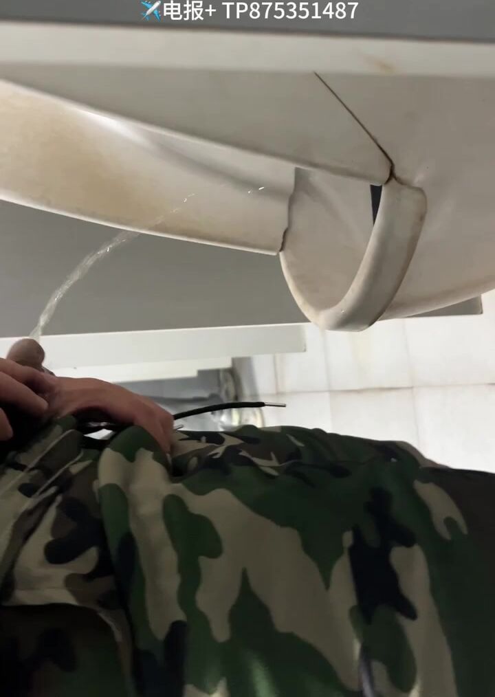 A male is pissing in the toilet. 11