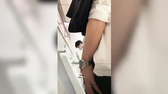 A male is pissing in the toilet. 12