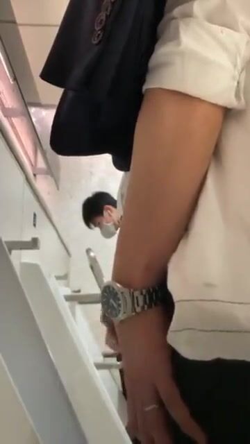 A male is pissing in the toilet. 12