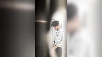 A male student is pissing in the toilet. 4