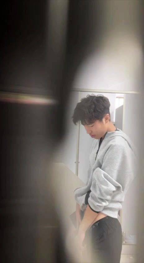 A male student is pissing in the toilet. 4