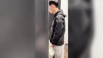 A male is pissing in the toilet. 14