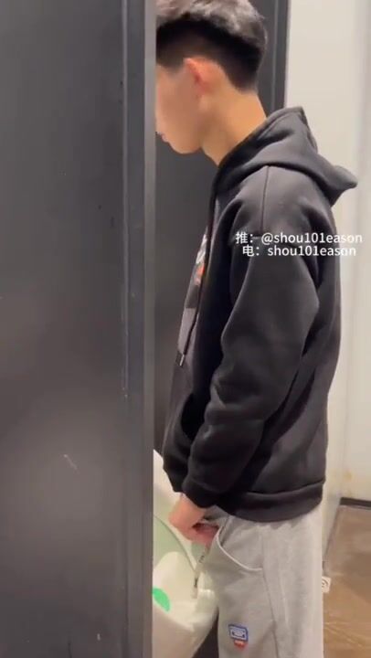 A male is pissing in the toilet. 14