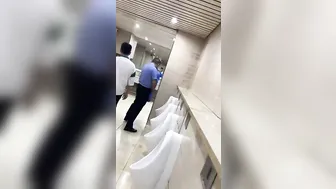 A male student is pissing in the toilet. 5