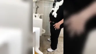Males are pissing in the toilet.