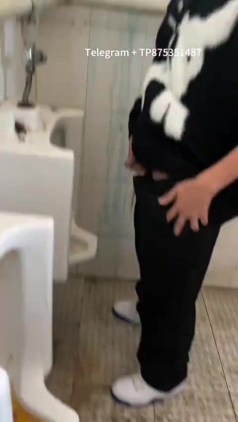 Males are pissing in the toilet.