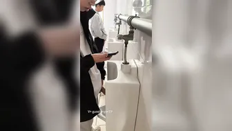 A male student is pissing in the toilet. 6