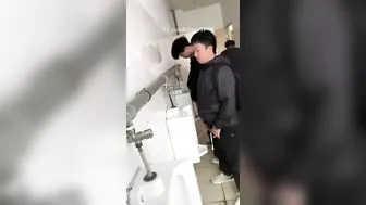 A male student is pissing in the toilet. 7