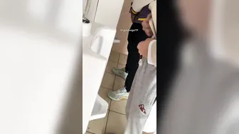 A male student is pissing in the toilet. 8