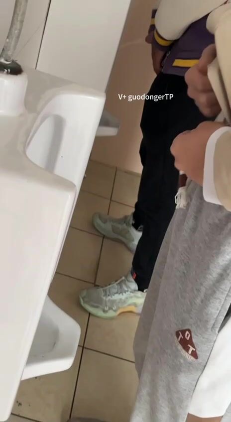 A male student is pissing in the toilet. 8
