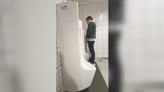 A male is pissing in the toilet. 24